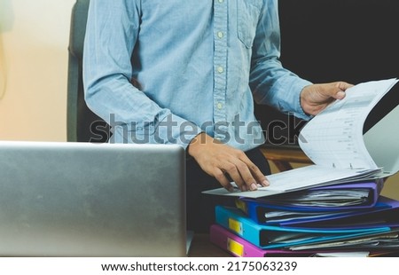 business man lifting a lot of documents business man hard working