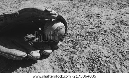 Baseball glove with ball on field closeup for sport, copy space on background.