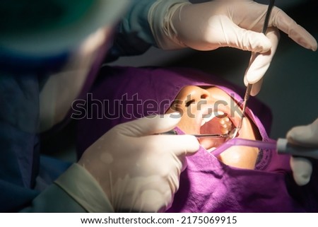 Tooth removal . Dental, dentists, dental laboratories in low light conditions. Oral health and teeth. Royalty-Free Stock Photo #2175069915