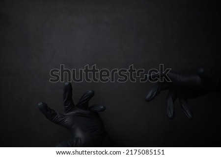 Background of hands in gloves. Black gloves. Hand gestures black gloves.