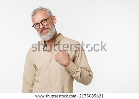 Cheerful caucasian mature middle-aged man freelancer wearing glasses holding hand close to heart, charity organization, coronary heart disease concept isolated in white background. Stay strong Royalty-Free Stock Photo #2175085621