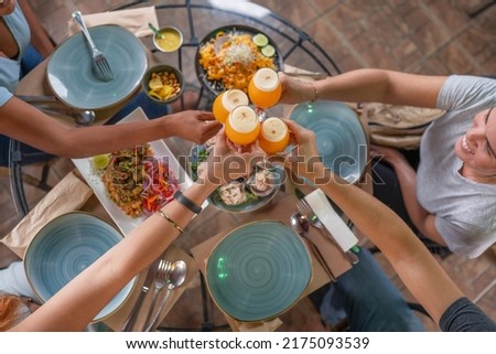 Top view of a group of people toasting with beer in a peruvian restaurant Royalty-Free Stock Photo #2175093539
