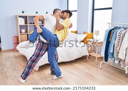 Two man couple dancing at bedroom