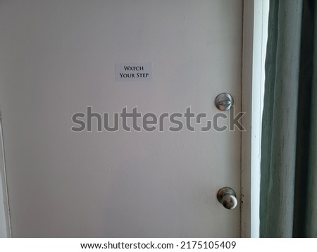 watch your step sign or sticker on locked or closed door