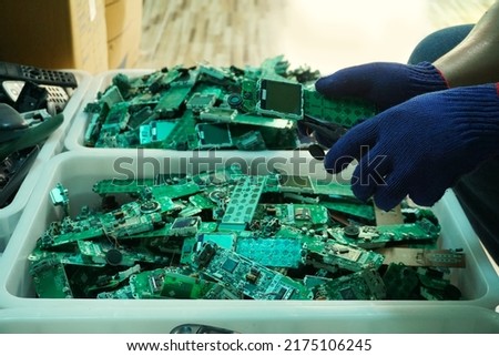 Telephone circuit board parts are being disassembled as electronic waste in the factory. Royalty-Free Stock Photo #2175106245