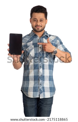 Young handsome man, businessman showing a blank screen of a smartphone or mobile or tablet phone on white background 