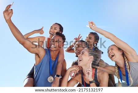 Group of diverse olympic athletes taking a selfie while having fun and showing hand gestures. Happy and cheerful runners taking a photo together. Young male sprinter taking a picture with athletes
