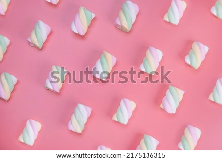 multi-colored chewy marshmallows on a pink background, the concept of a birthday, holiday, fun, trendy sweet background