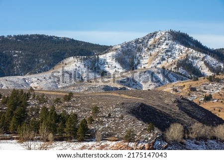 Horsetooth Reservoir in Larimer County, Colorado.  Rocky bluffs and a frozen landscape. Snowy background with stone bluffs and blue sky.  