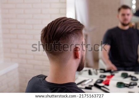 
Male head with stylish haircut on barbershop background
 Royalty-Free Stock Photo #2175163727