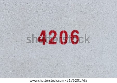 Red Number 4206 on the white wall. Spray paint.
