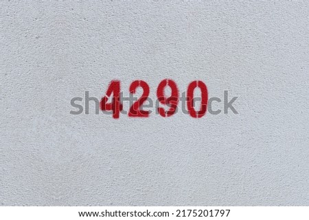 Red Number 4290 on the white wall. Spray paint.
