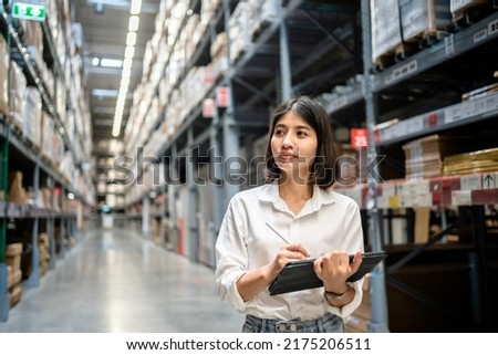 Woman worker using digital tablet checking the stock inventory, Smart warehouse management system, Supply chain and logistic network technology concept. Royalty-Free Stock Photo #2175206511