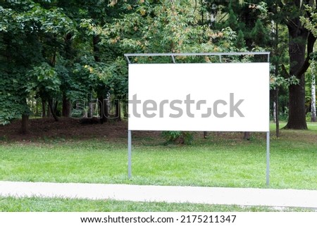 On the lawn is a horizontal empty billboard for information and advertising.