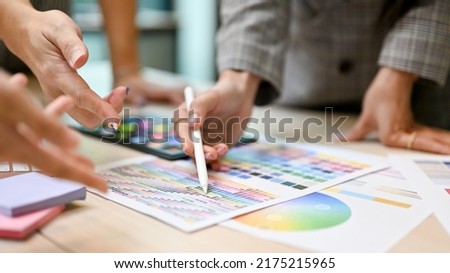 A team of professional graphic designer or web developer having a meeting to discuss their project. cropped image