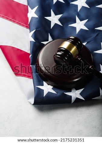 Wooden gavel of the judge on the background of the American flag. Court, crime, punishment, rule of law, constitution Close-up. There are no people in the photo. Banner, poster.