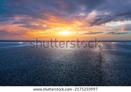 Asphalt road platform and sky sunset clouds background Royalty-Free Stock Photo #2175233997