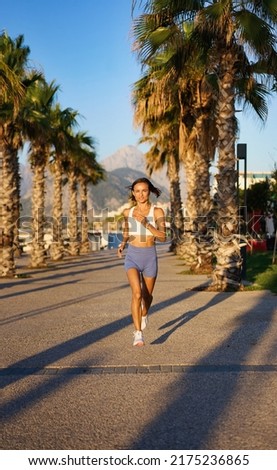 young healthy lifestyle woman running at sunrise beach. High quality photo
