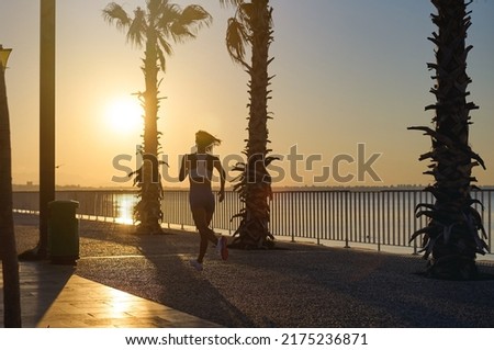 young healthy lifestyle woman running at sunrise beach. High quality photo
