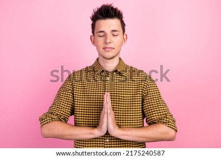 Portrait of peaceful guy hands together practice chakra workout isolated on pastel color background