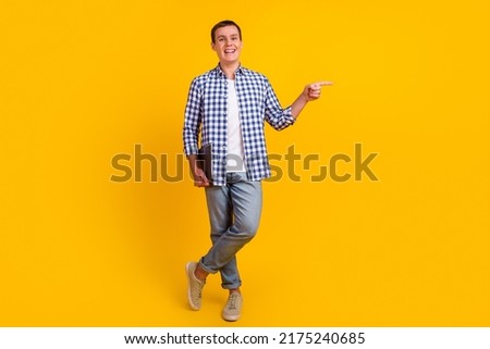 Photo of cheerful caucasian smart young man holding laptop smiling point empty space ads isolated shine background