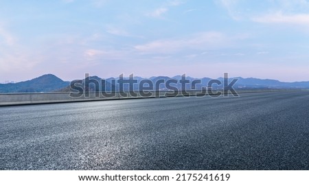 Asphalt road and mountain natural scenery at dusk Royalty-Free Stock Photo #2175241619