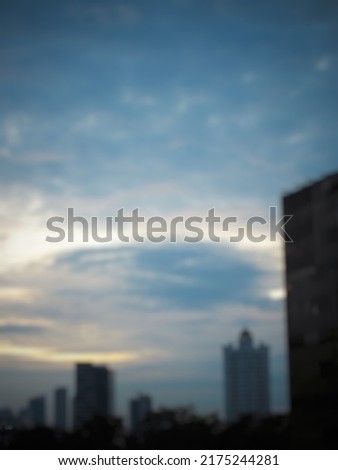 Unfocus. abstract blurred picture of silhoutte of urban buildings against the background of a slightly bluish evening sky