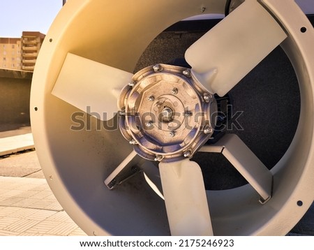 Large industrial axial fan on a sunset background. Close view. Royalty-Free Stock Photo #2175246923