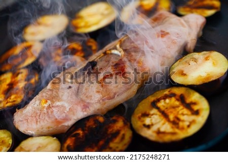 Close-up of delicious pork with eggplant frying on grill