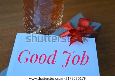 Bottle of expensive drink, gift with red bow and inscription good job, greeting card concept