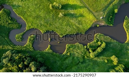 View from the height of the winding river. Picturesque nature aerial photography.