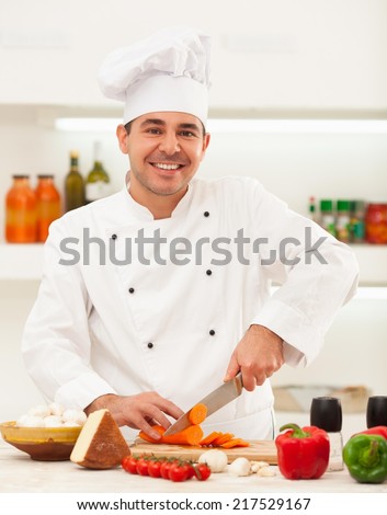 Male chef preparing vegetables for cooking.
