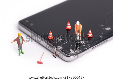 Miniature people working on the broken display