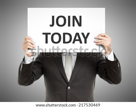 A business man holding a paper in front of his face with the text join  today