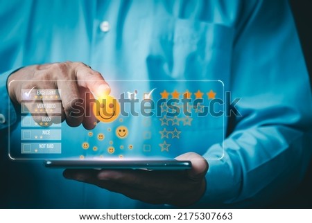 A young businessman is using a mobile phone to rate the services of an online store after making a purchase,Satisfaction survey concept.customer services best excellent business rating experience. 