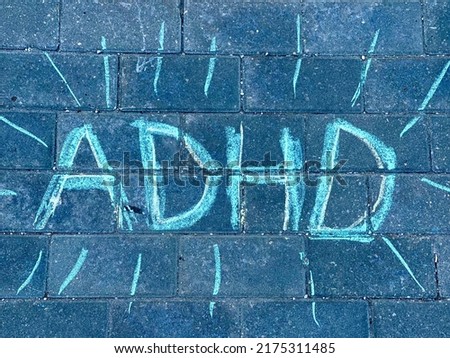 ADHD, drawing and writing with chalk on asphalt.
