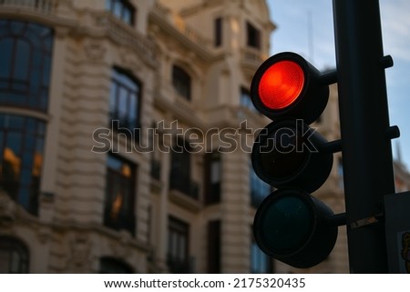 Red traffic light in the middle of a cross. Transportation industry.