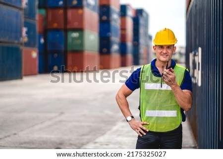 Professional engineer container cargo foreman in helmets working standing and using walkie talkie checking stock into container for loading.logistic transport and business industry export