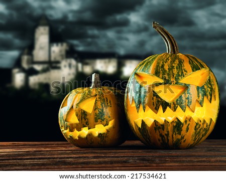 Halloween pumpkin on wooden planks with blur background.