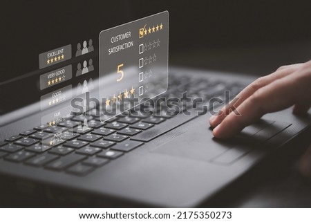 Hand touching to pad of computer laptop to excellent score from customer evaluation after client use product and service concept. Royalty-Free Stock Photo #2175350273