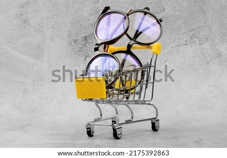 Eyeglasses in a shopping cart. Glasses sale, glasses shop Royalty-Free Stock Photo #2175392863