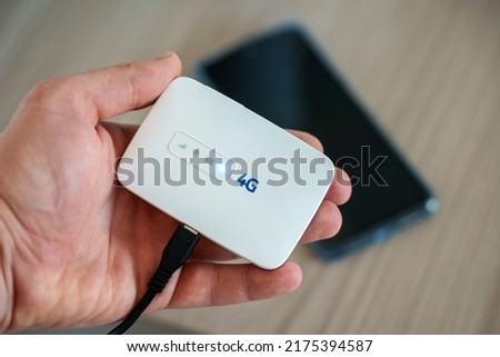 Modern wireless pocket 4g wifi modem. Royalty-Free Stock Photo #2175394587