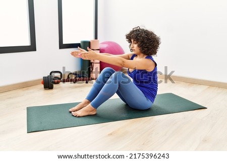 Young middle east woman stretching at sport center