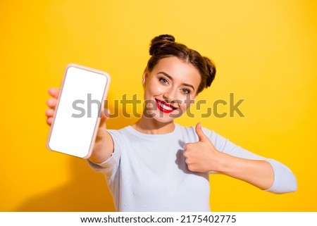 Photo of funky confident lady wear long sleeve showing modern gadget touch screen empty space isolated yellow color background