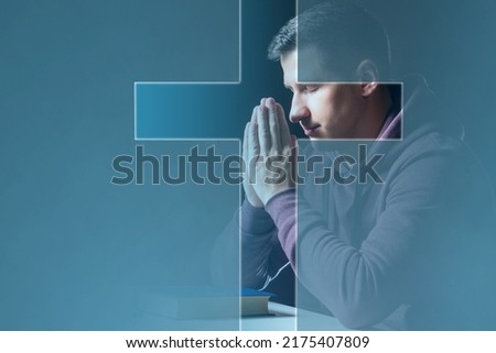 Believing Christian. Man prays to God. Christian crucifix in front of praying man. Catholic guy with closed eyes. Christian in pose of prayer. Concept of study of Catholic religion. Appeal to God Royalty-Free Stock Photo #2175407809