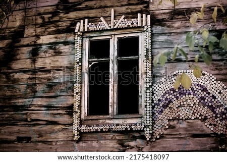A strange dark mysterious window with broken glass in an old abandoned wooden broken spooky house. Abstract background in horror style. Concept of fear