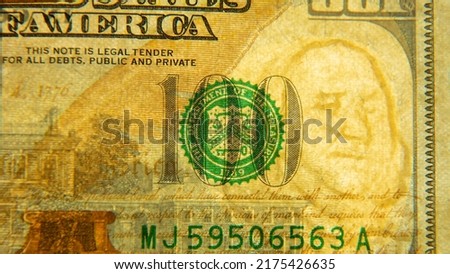 A hundred-dollar bill in close-up with a watermark. Verifying the authenticity of the banknote.