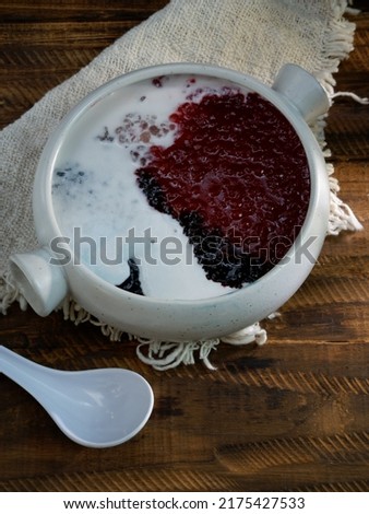 Indonesian traditional sweet porridge for dessert and very famous during Ramadhan the colour are Red, dark blue, and white. the colour is like american flag ,Bubur Sagu Mutiara. selective focus
