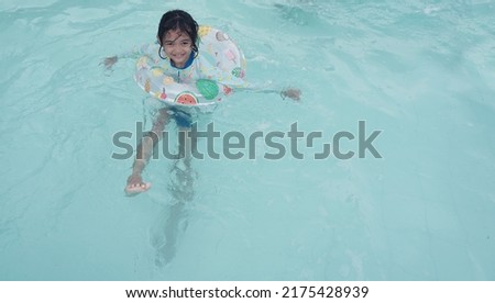 Portraits of Asian girl wearing a swimsuit. Swimming in the pool