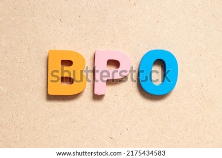 Color alphabet letter in word BPO (Abbreviation of Business Process Outsourcing) on wood background